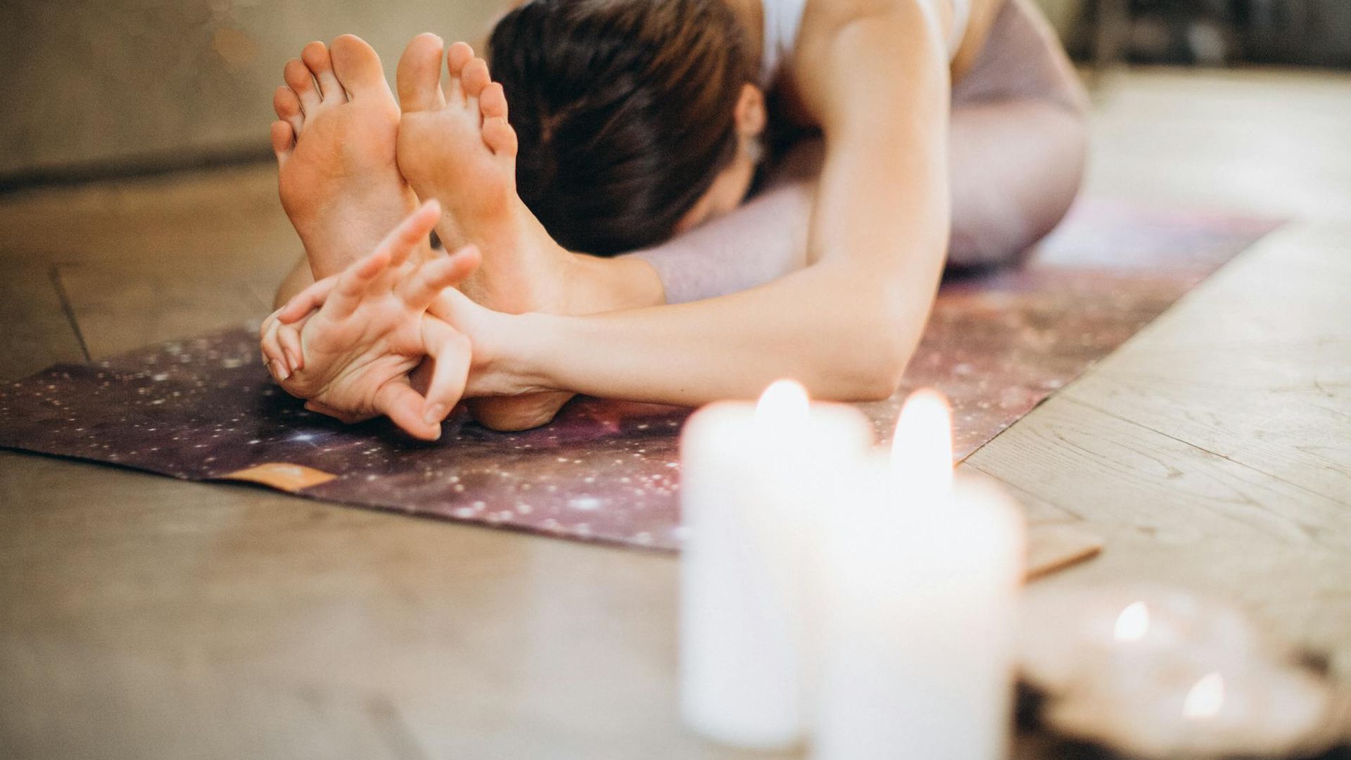 Serene yoga atmosphere with warm lighting in a dark room